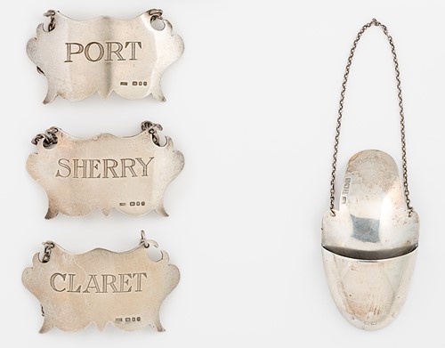 Lot 306 - Three 20th century silver bottle labels together with a drip catcher
