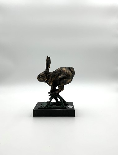 Lot 203 - A bronzed patinated model of a running hare,...