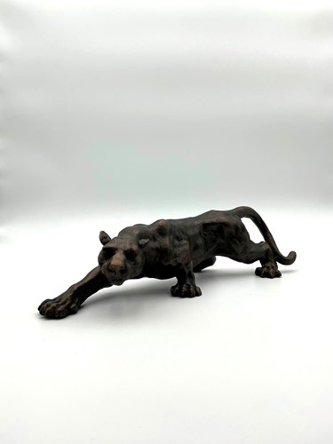 Lot 201 - A bronzed metal sculpture of a prowling jaguar,...