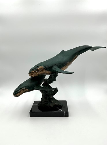 Lot 111 - A bronzed green patinated model of a pair of...