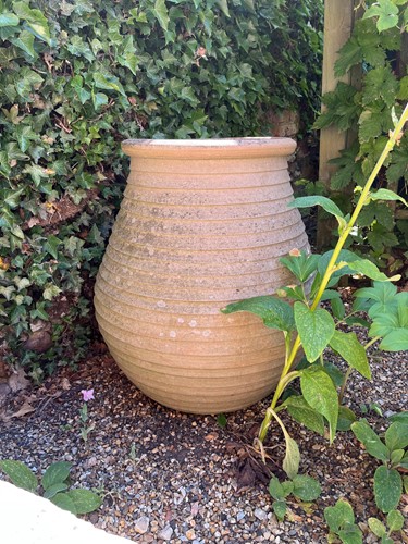 Lot 766 - A large ribbed terracotta olive jar shaped planter, modern