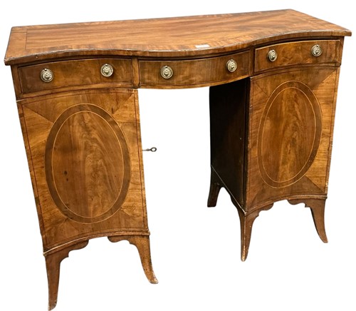 Lot 574 - A Regency mahogany serpentine sideboard, the...