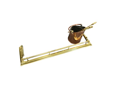 Lot 502 - A brass fender, a set of brass fire irons and...