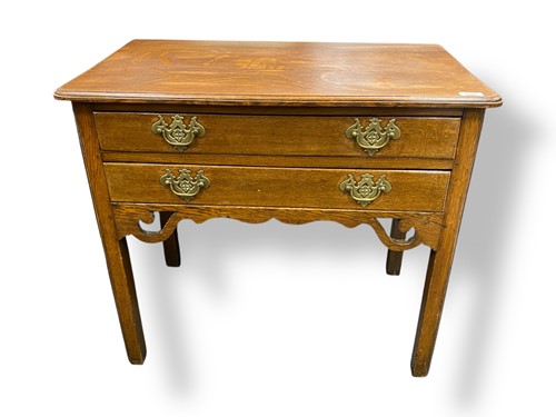 Lot 536 - A George III oak lowboy, two long drawers on...