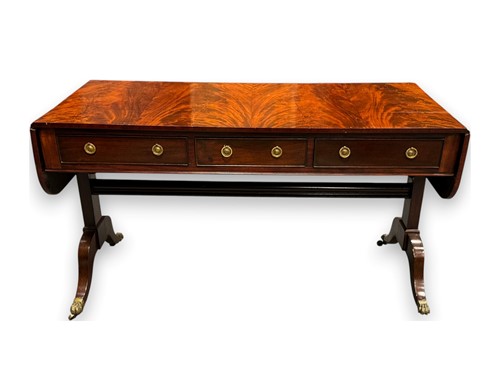 Lot 650 - A large Regency style mahogany sofa...