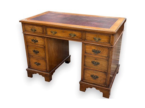 Lot 576 - A reproduction walnut twin pedestal desk,...