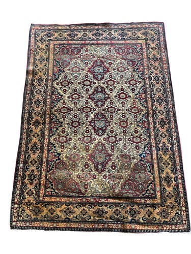 Lot 573 - A Persian fine wool rug with repeating floral...