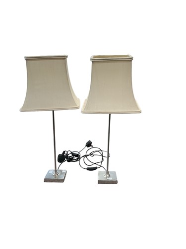 Lot 209 - A pair of slender polished white metal lamps...