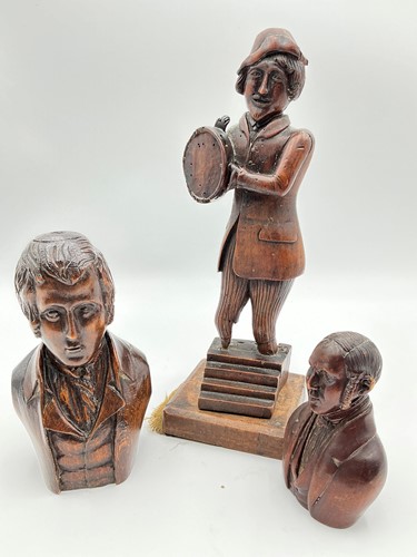 Lot 143 - A carved wood figure of a musician, together...