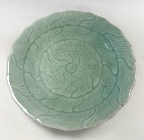 Lot 15 - A Chinese celadon lotus plate, Qing Dynasty, 19th century