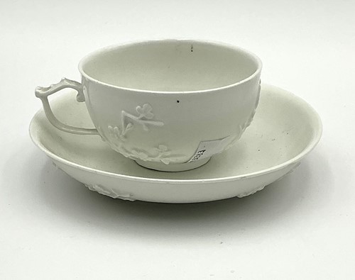 Lot 56 - A Meissen blanc de chine tea cup and saucer,...