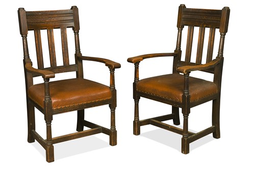 Lot 348 - Attributed to Liberty & Co., a pair of oversized Arts & Crafts oak elbow chairs