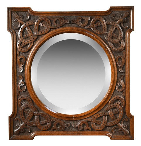Lot 354 - In the manner of Arthur Simpson of Kendal, a carved oak mirror