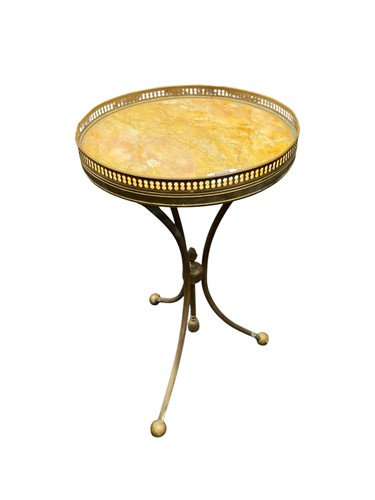 Lot 523 - A brass marble topped tripod table with...