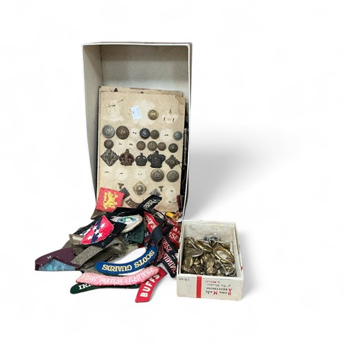 Lot 116 - A box of military cloth badges and insignia,...