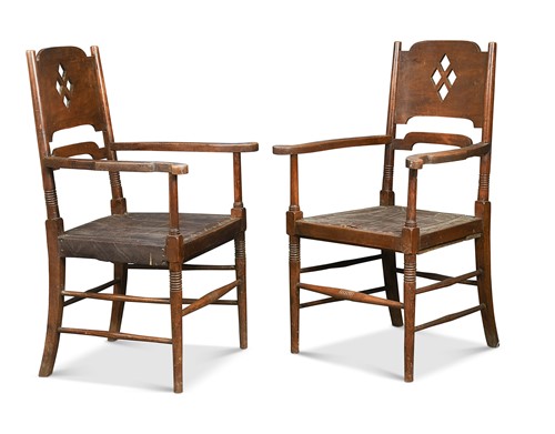 Lot 342 - In the manner of William Birch, a pair of Arts & Crafts stained ash elbow chairs
