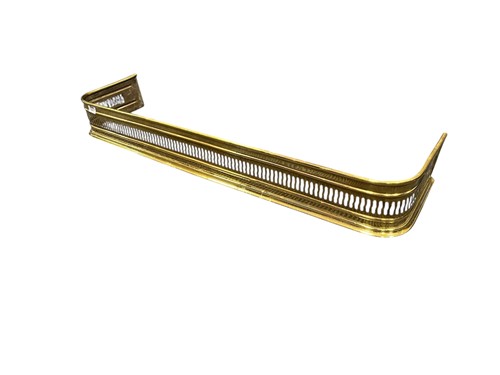 Lot 603 - A pierced brass fender 12.5 x 127.5 x 27cm