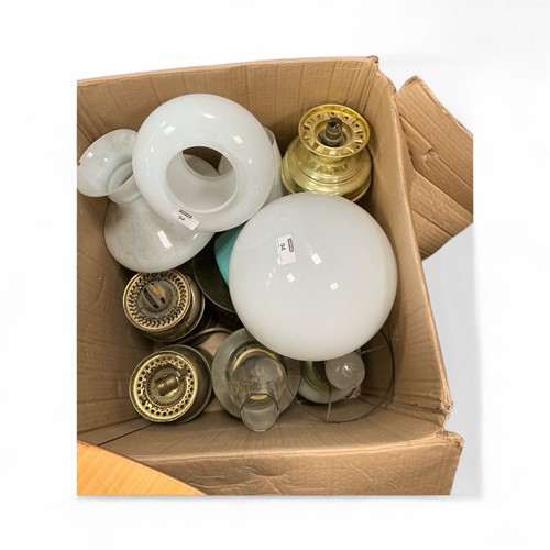 Lot 94 - A box of brass oil lamps and shades,...