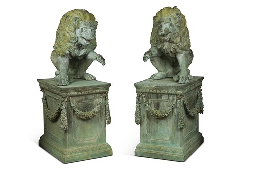 Lot A pair of verdigris patinated bronze garden lions on plinths