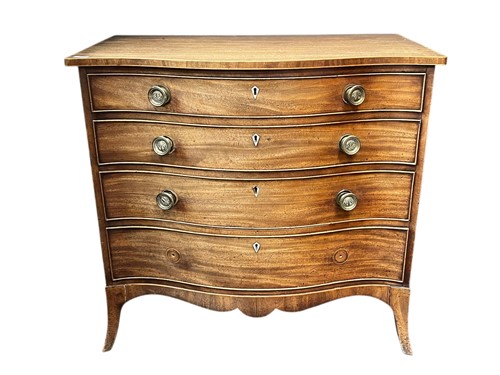 Lot 539 - A late George III mahogany serpentine chest of...