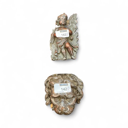 Lot 142 - Carvings to include a lion mask and a putto