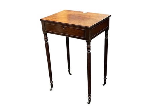 Lot 515 - A late Regency mahogany work table, the lift...