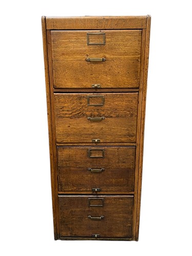 Lot 549 - An early 20th Century oak four drawer filing...