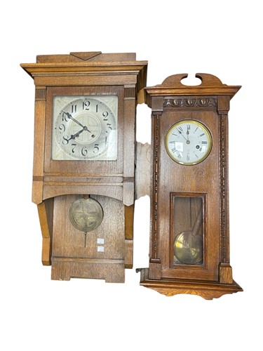 Lot 552 - An oak Arts and Crafts style wall clock, 76cm...