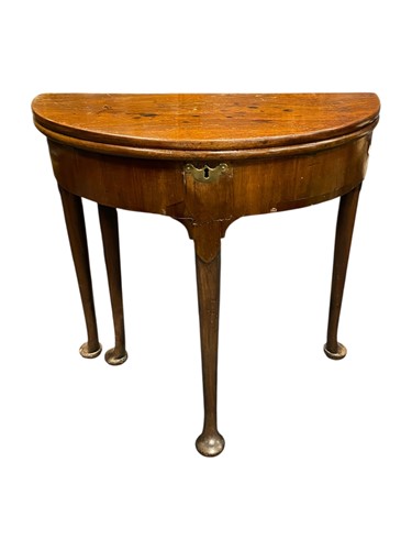 Lot 586 - An 18th century mahogany demi-lune tea table...