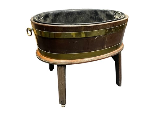 Lot 590 - A George III mahogany and brass-bound oval...