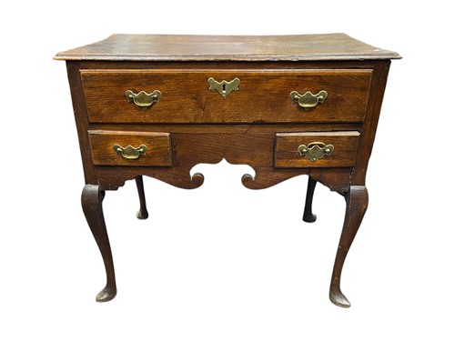 Lot 534 - An 18th century oak lowboy with one long over...