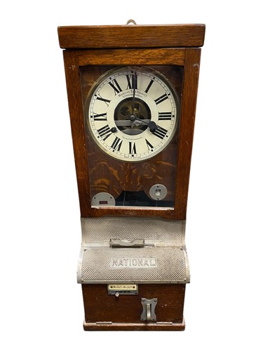Lot 528 - A National Time Recorder oak cased clock...