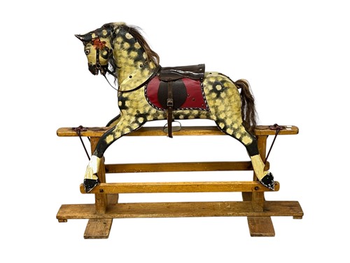 Lot 677 - A dapple grey painted wooden rocking horse,...
