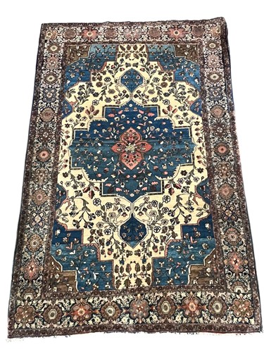 Lot 684 - A Persian style wool rug with central...