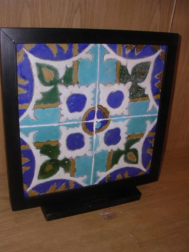 Lot 102 - A frame of four Safavid cuerda seca pottery tiles, possibly 17th century