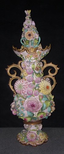 Lot 68 - A mid 19th century Staffordshire floral encrusted vase and cover