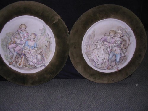Lot 110 - A pair of late 19th century German bisque wall plaques of lovers