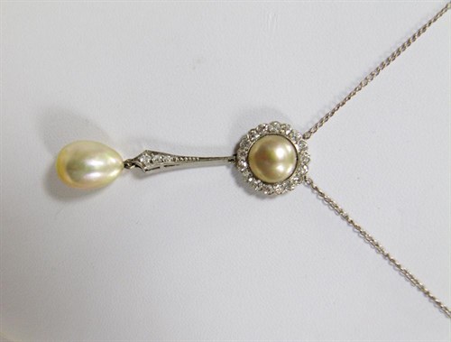 Lot 235 - A circular pendant with half pearl centre