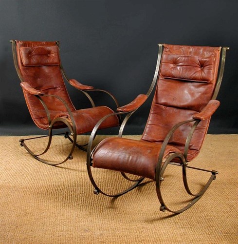 Lot 535 - A pair of early 20th century bent steel rocking chairs in the manner of R. W. Winfield