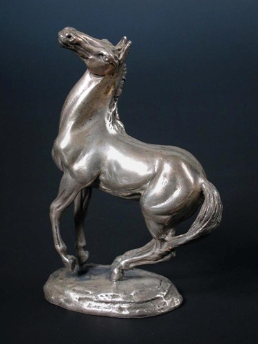 Lot 422 - After Lorne McKean, a cast silver model of a rearing horse