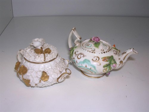 Lot 87 - Two early Victorian floral encrusted miniature tea pots and covers