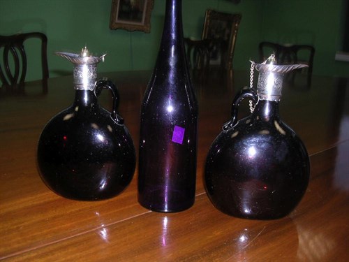 Lot 198 - A pair of electroplate mounted deep amber claret jugs and an amethyst carafe