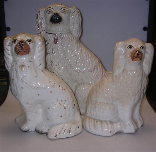 Lot 24 - Three late 19th century Staffordshire seated spaniels