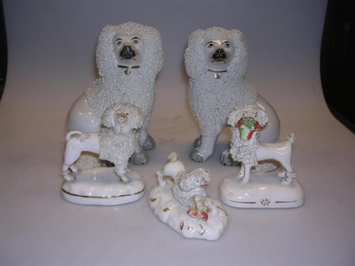 Lot 27 - A pair and three other Staffordshire poodle figures