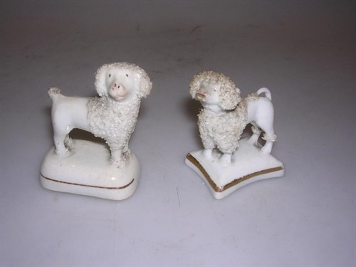 Lot 28 - Two mid 19th century Staffordshire porcelaneous figures of poodles