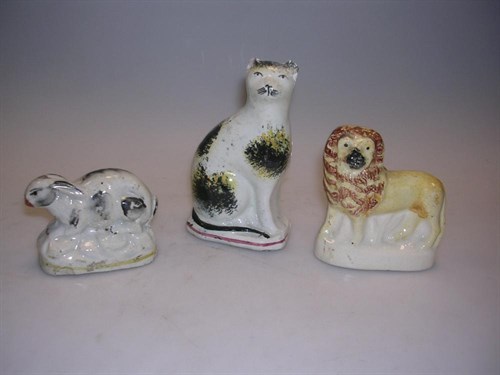 Lot 44 - A 19th century Staffordshire rabbit, lion and cat