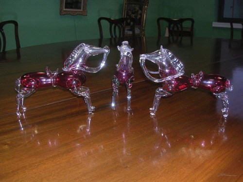 Lot 202 - Three 20th century cranberry glass horses