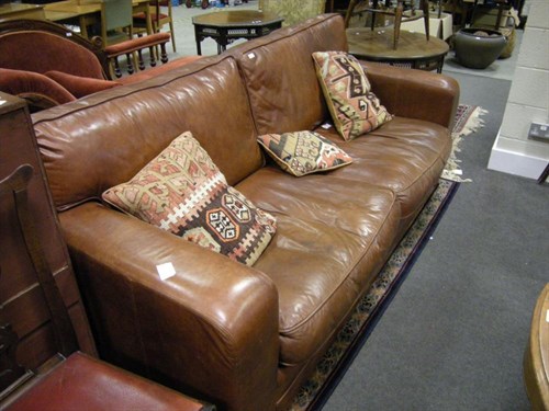 Lot 82 - A leather sofa
