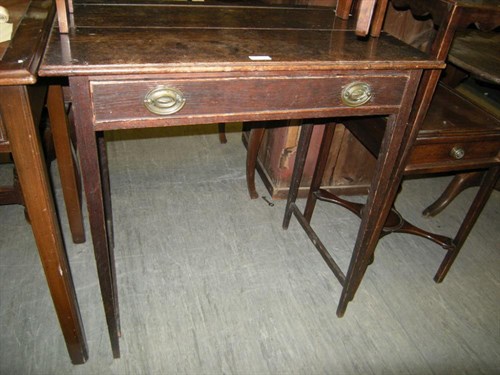 Lot 15 - A George III oak single drawer side table.