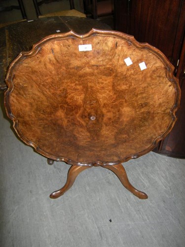 Lot 10 - A walnut tilt top table